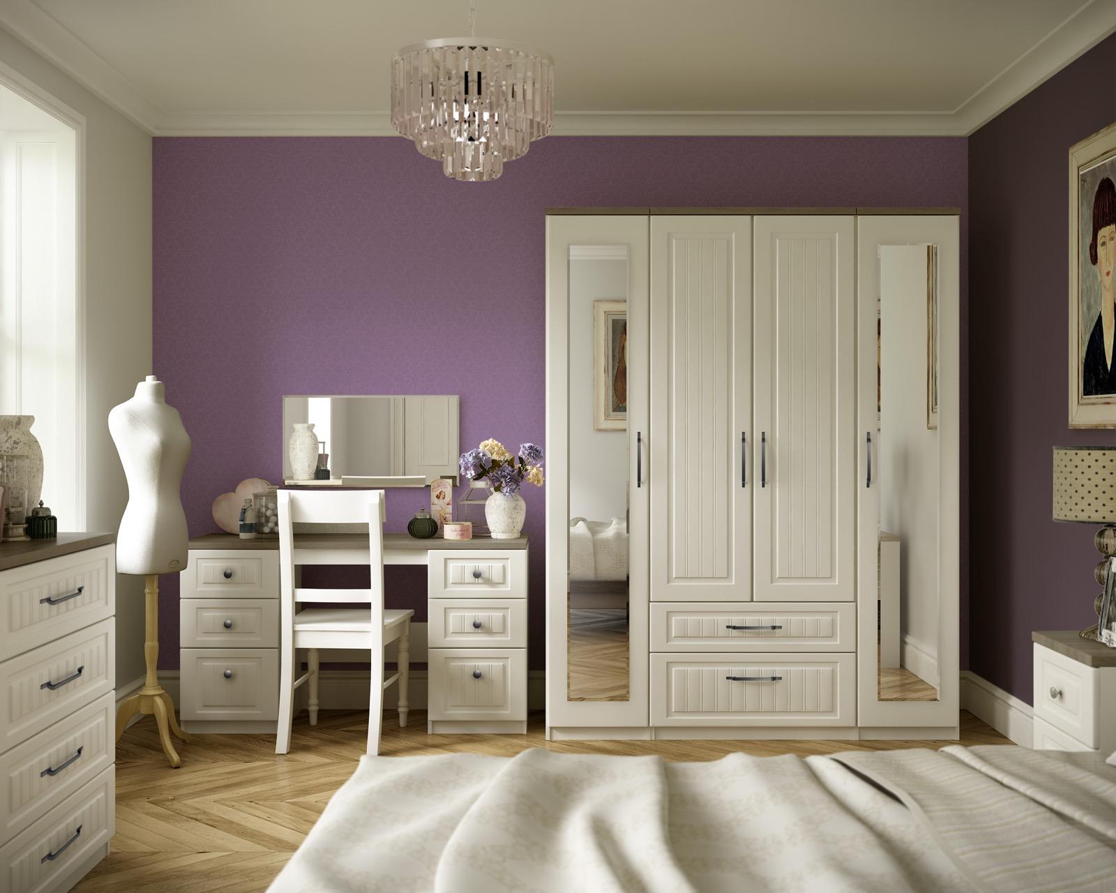 An ivory shaker-style bedroom suite with a mirrored wardrobe, dressing table and chest of drawers.