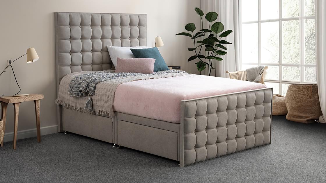 A Sweet Dreams Opulence bedstead in mink velvet with a deep cube-tufted headboard and footboard, in a bright room with a tall window