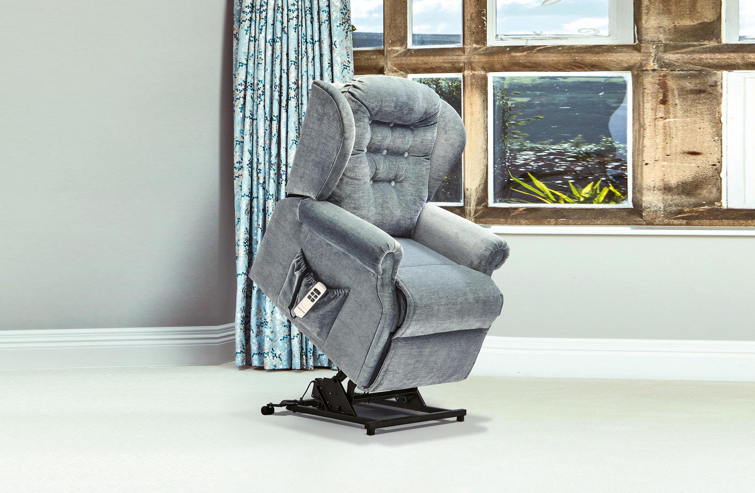 A Sherborne Lynton rise-and-recline chair raised beside a stone-mullioned window