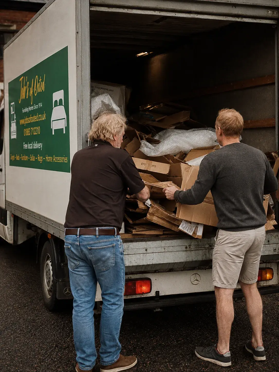 Old furniture being loaded into the Job's of Oxted van for removal.