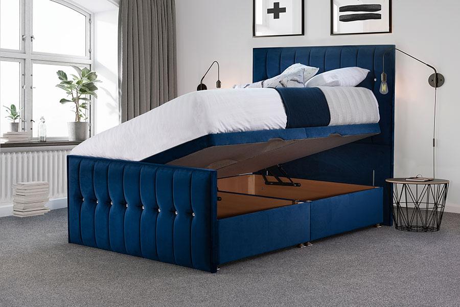 An upholstered ottoman bed with its base lifted to reveal the storage beneath.