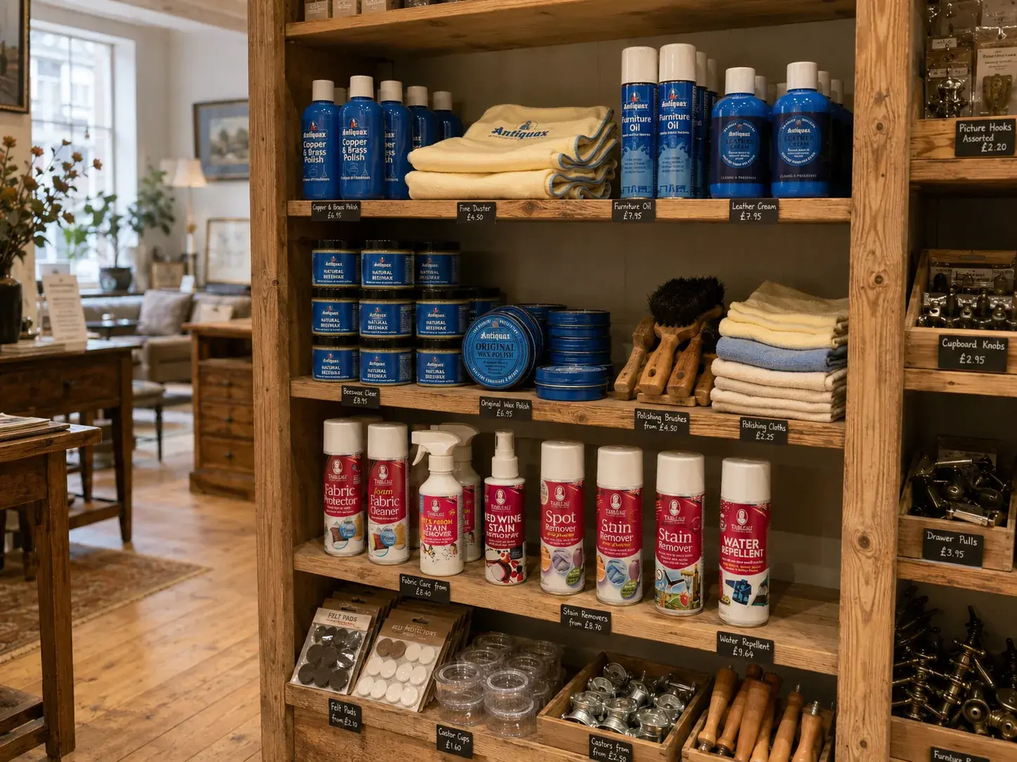 Waxes, polishes, cleaners, brushes, cloths, felt pads and castor cups stocked on the shop-floor shelving.